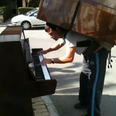 VIDEO: Man Plays Piano While Balancing Another Piano on His Back