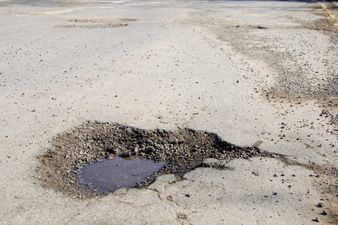 Drastic Action – Woman Proves Her Point By Taking A Bath In A Pothole