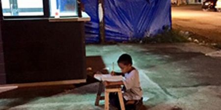 Young Boy Does His Homework Using Light From McDonald’s Window