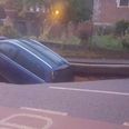 A huge sinkhole has appeared in a road in London and swallowed a car