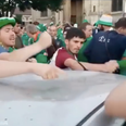 Irish fans sing while fixing a dent in a car in France