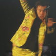 Harry Styles takes a tumble after fans throw kiwis onto the stage