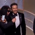 Tommy Wiseau tries to grab the mic after James Franco’s Golden Globes win