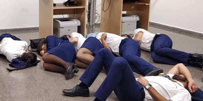 Six Ryanair crew have lost their jobs after staging a photo sleeping on an airport floor