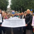 Hundreds gather outside Dáil Éireann to call for an end to maternity restrictions